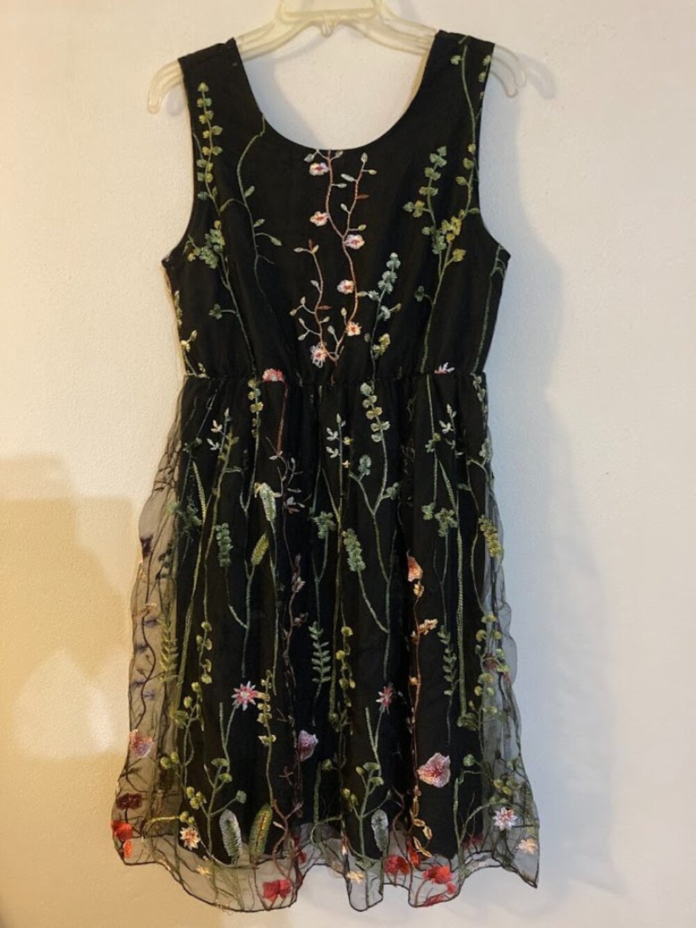 Women's black knee-length dress featuring floral lace embroidery